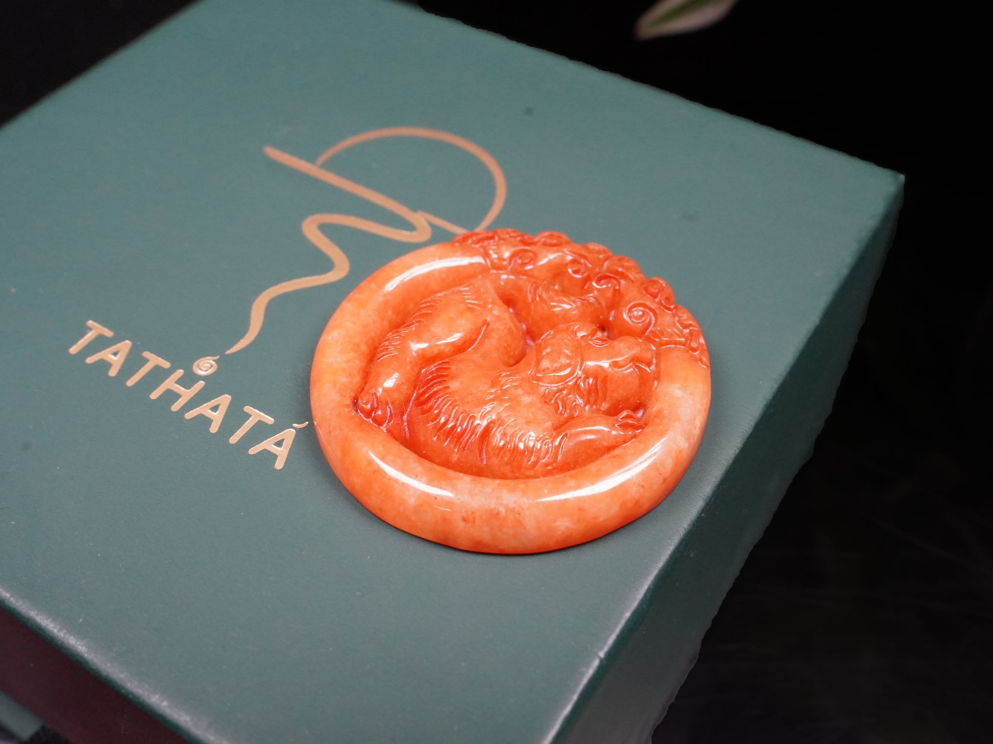 A glowing orange red dog loose jadeite.