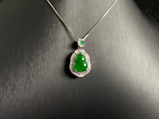 An imperial green jade gourd pendant, embraced by a diamond studded 925 silver frame.
