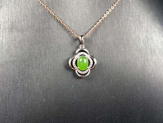 A vibrant clover green cabochon Hetian jade pendant.