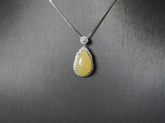 A pale yellow teardrop jadeite pendant.