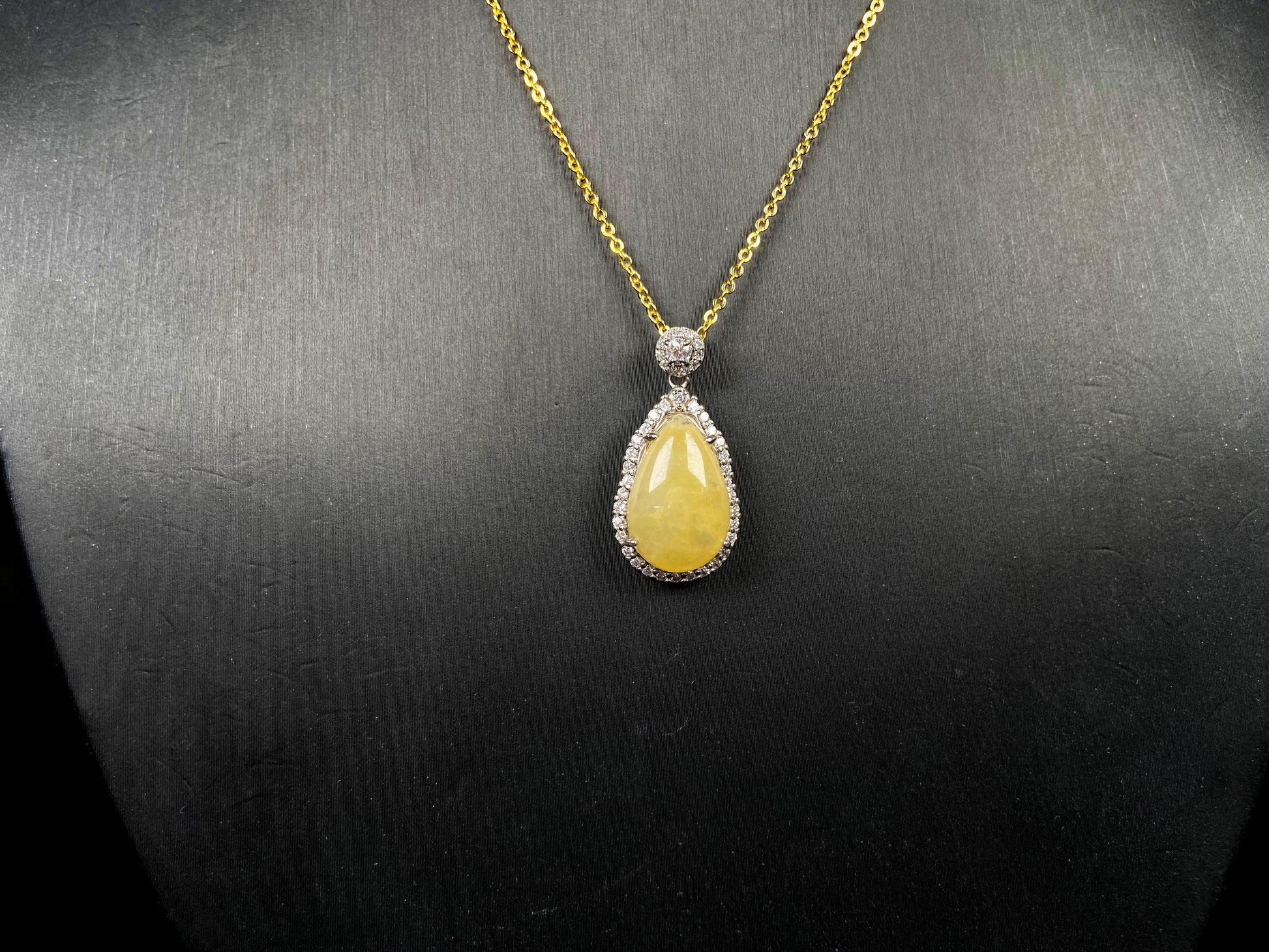 A yellow jadeite pendant.