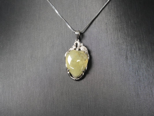 A soft pale yellow heart jadeite pendant.