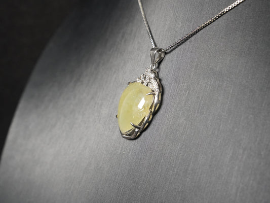 A soft pale yellow heart jadeite pendant.