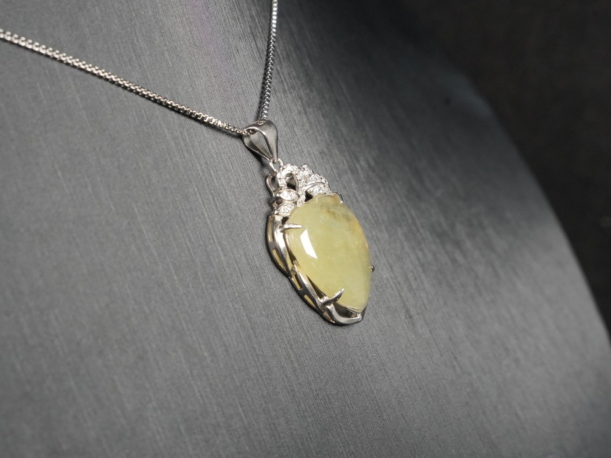 A soft pale yellow heart jadeite pendant.