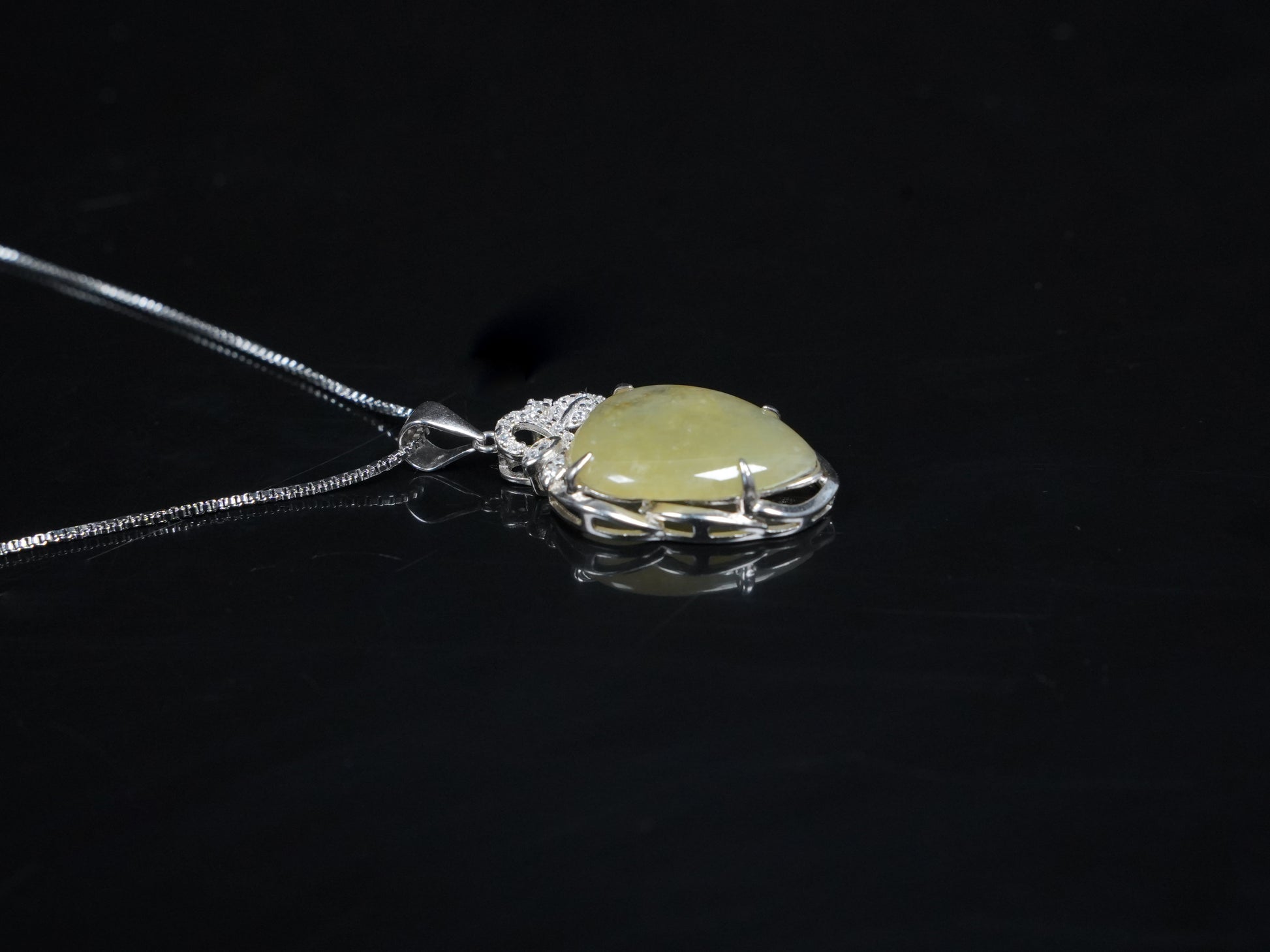 A soft pale yellow heart jadeite pendant.