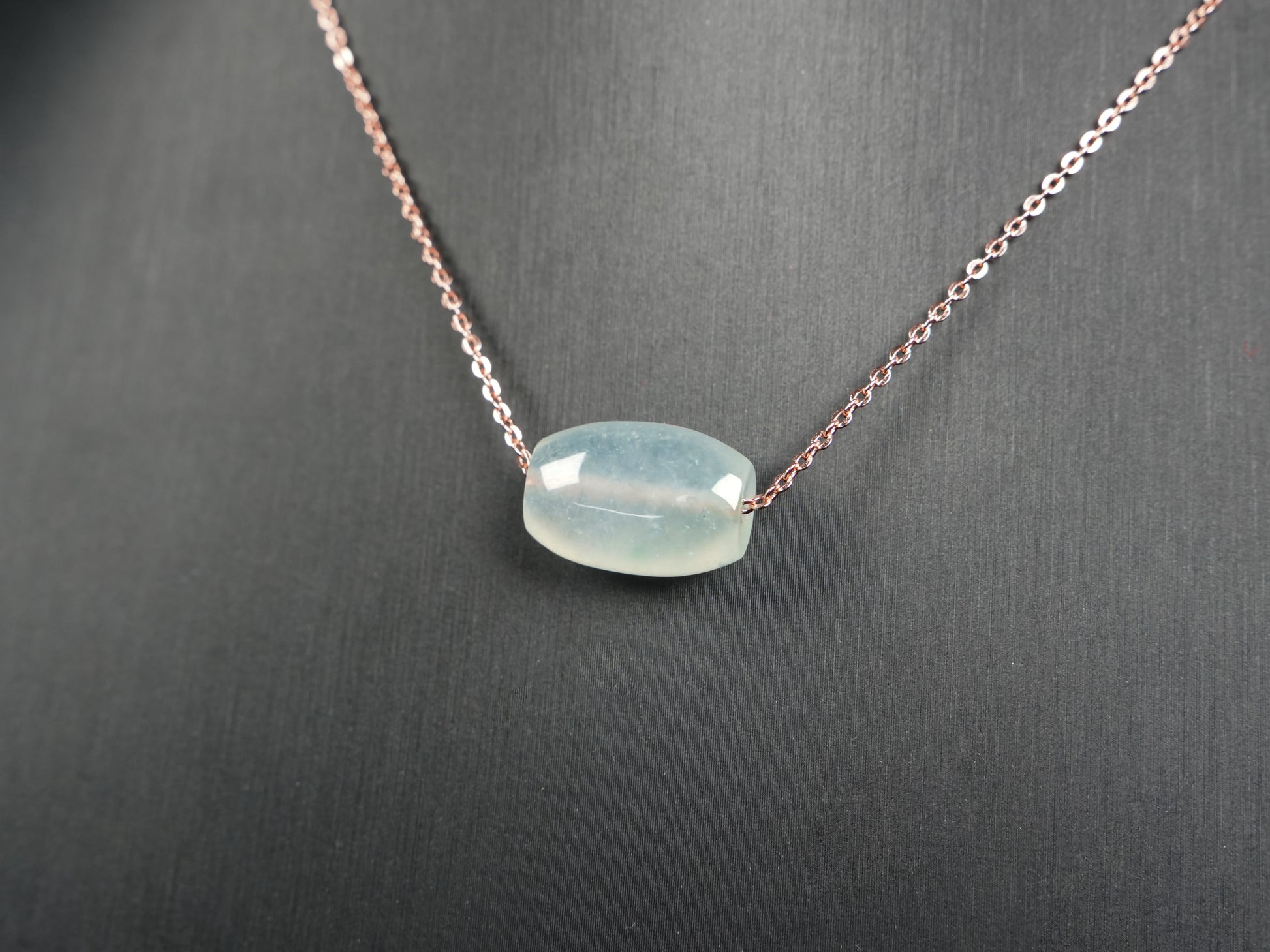 A translucent pale aqua Lu Lu Tong jadeite pendant.