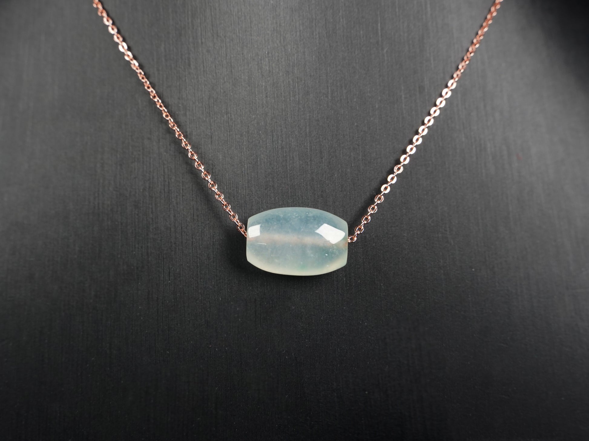 A translucent pale aqua Lu Lu Tong jadeite pendant.