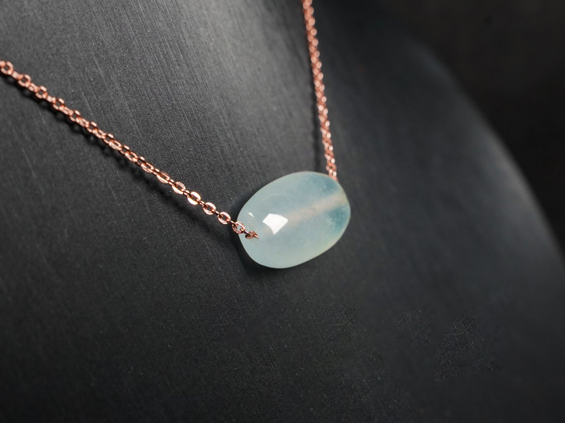 A translucent pale aqua Lu Lu Tong jadeite pendant.
