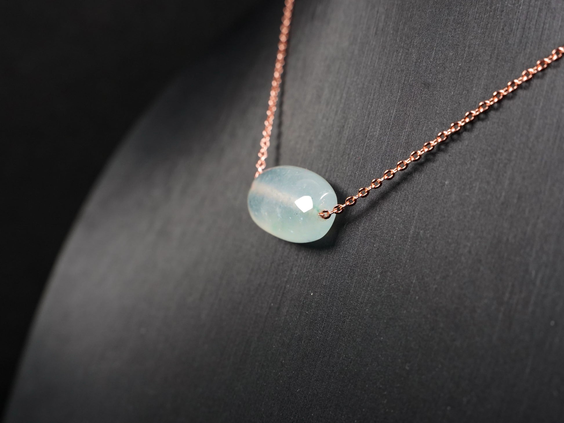 A translucent pale aqua Lu Lu Tong jadeite pendant.