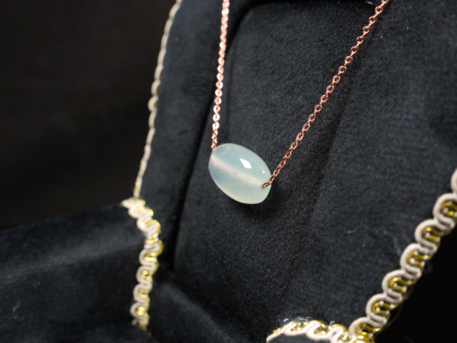 A translucent pale aqua Lu Lu Tong jadeite pendant.