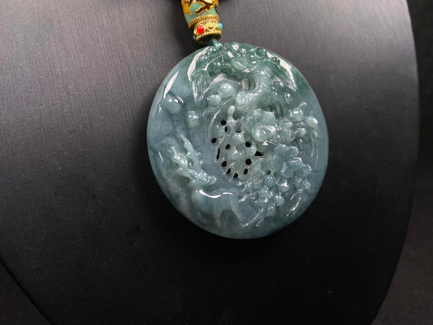 A cyan blue deer jadeite pendant.