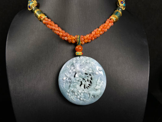 A pale white blue deer coral jadeite pendant.