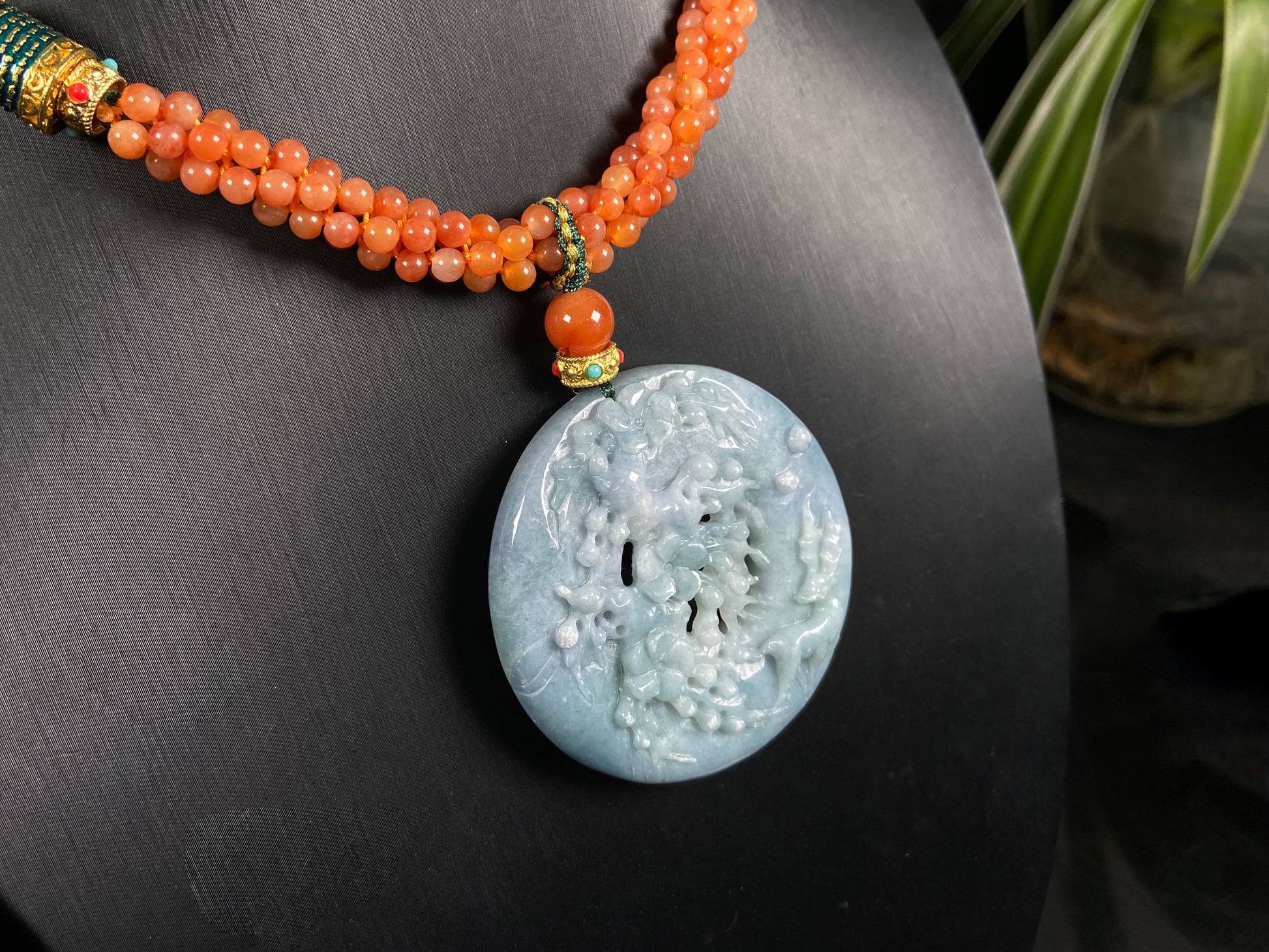 A pale white blue deer coral jadeite pendant.