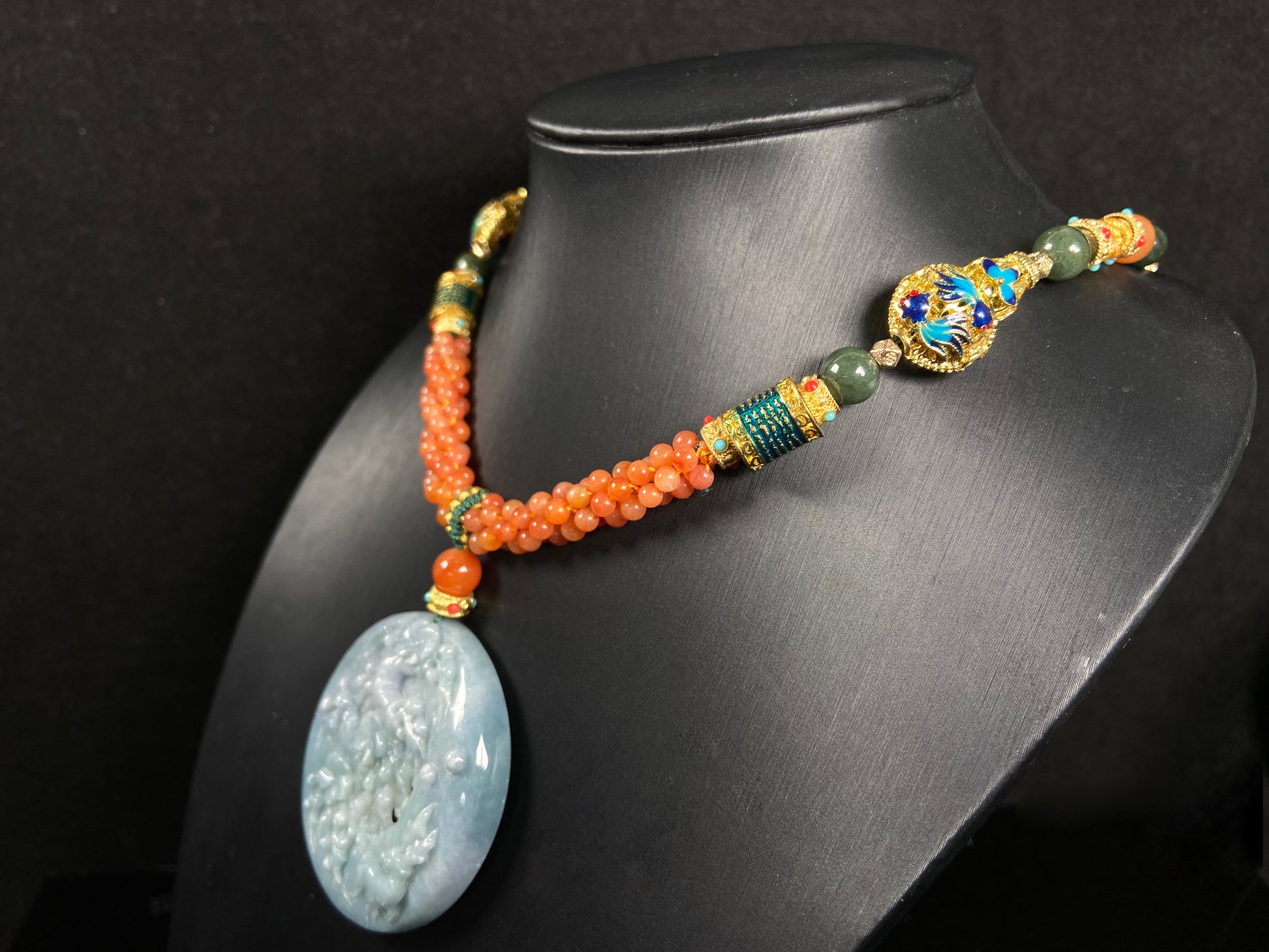 A pale white blue deer coral jadeite pendant.