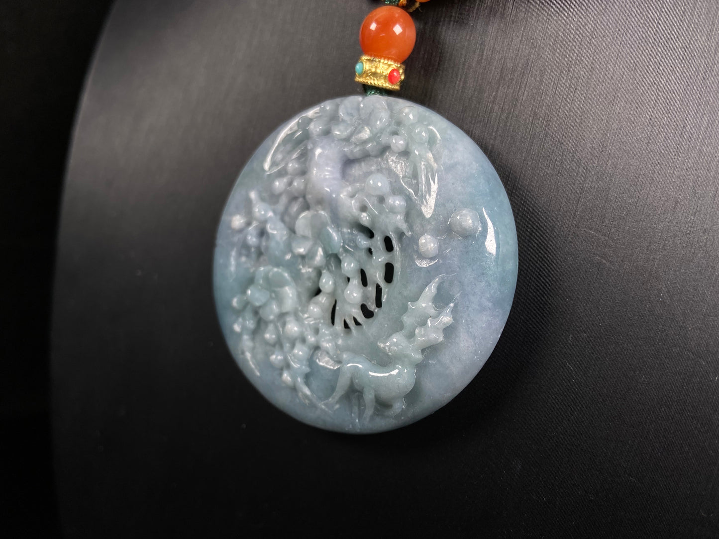 A pale white blue deer coral jadeite pendant.