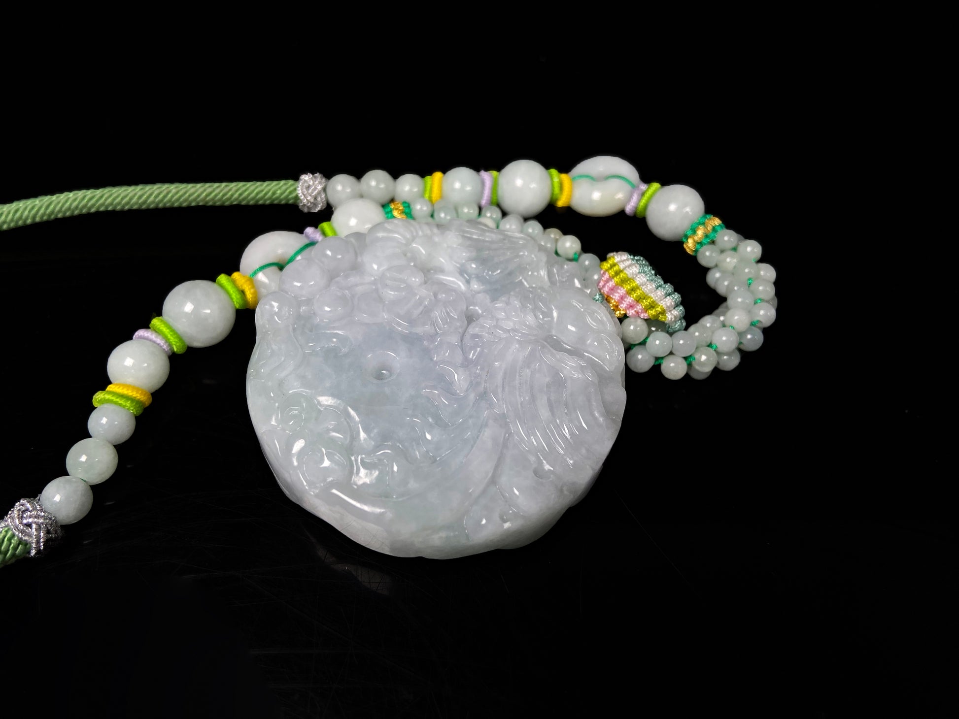 A phoenix among clouds jadeite pendant.