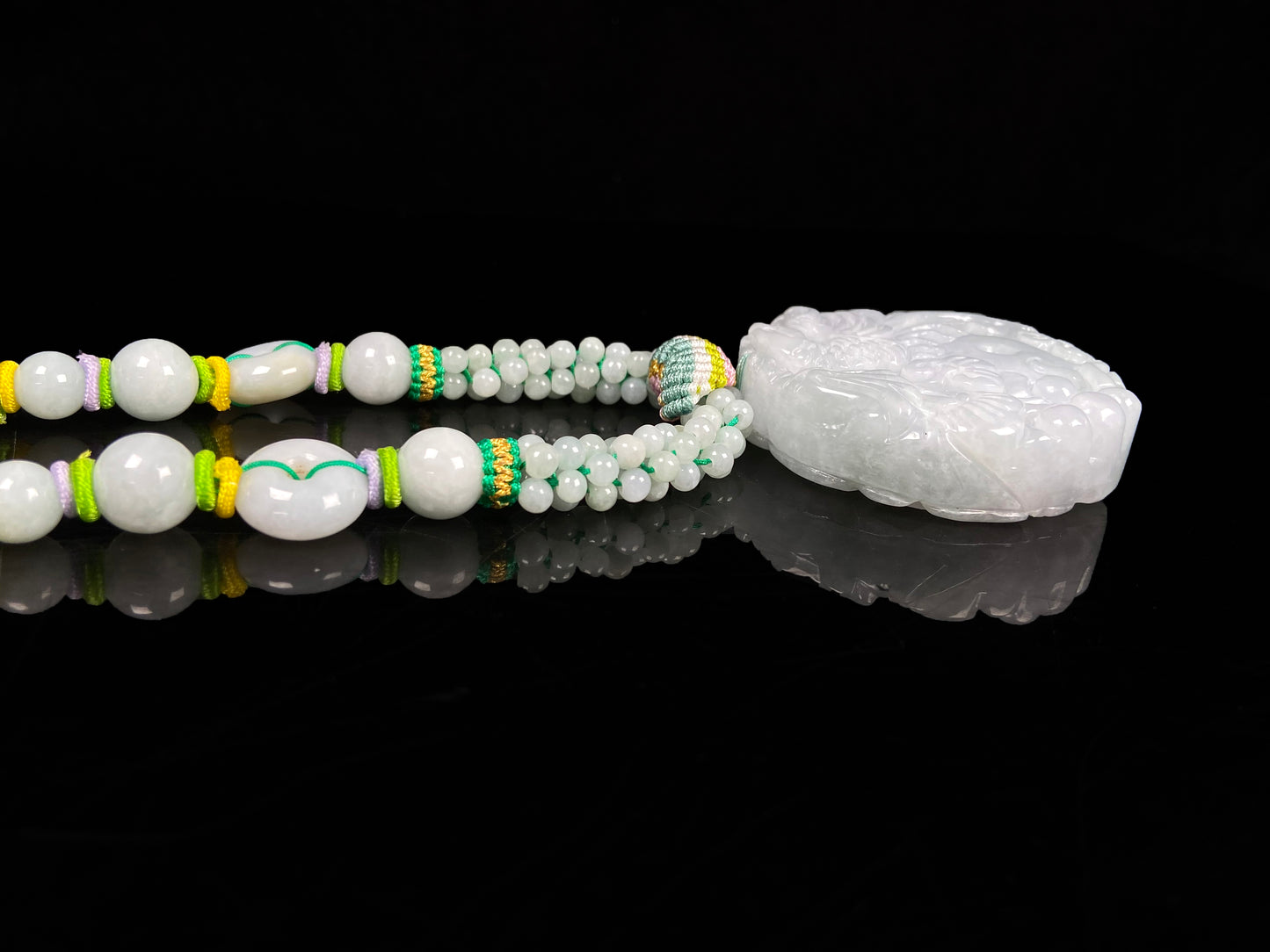 A phoenix among clouds jadeite pendant.