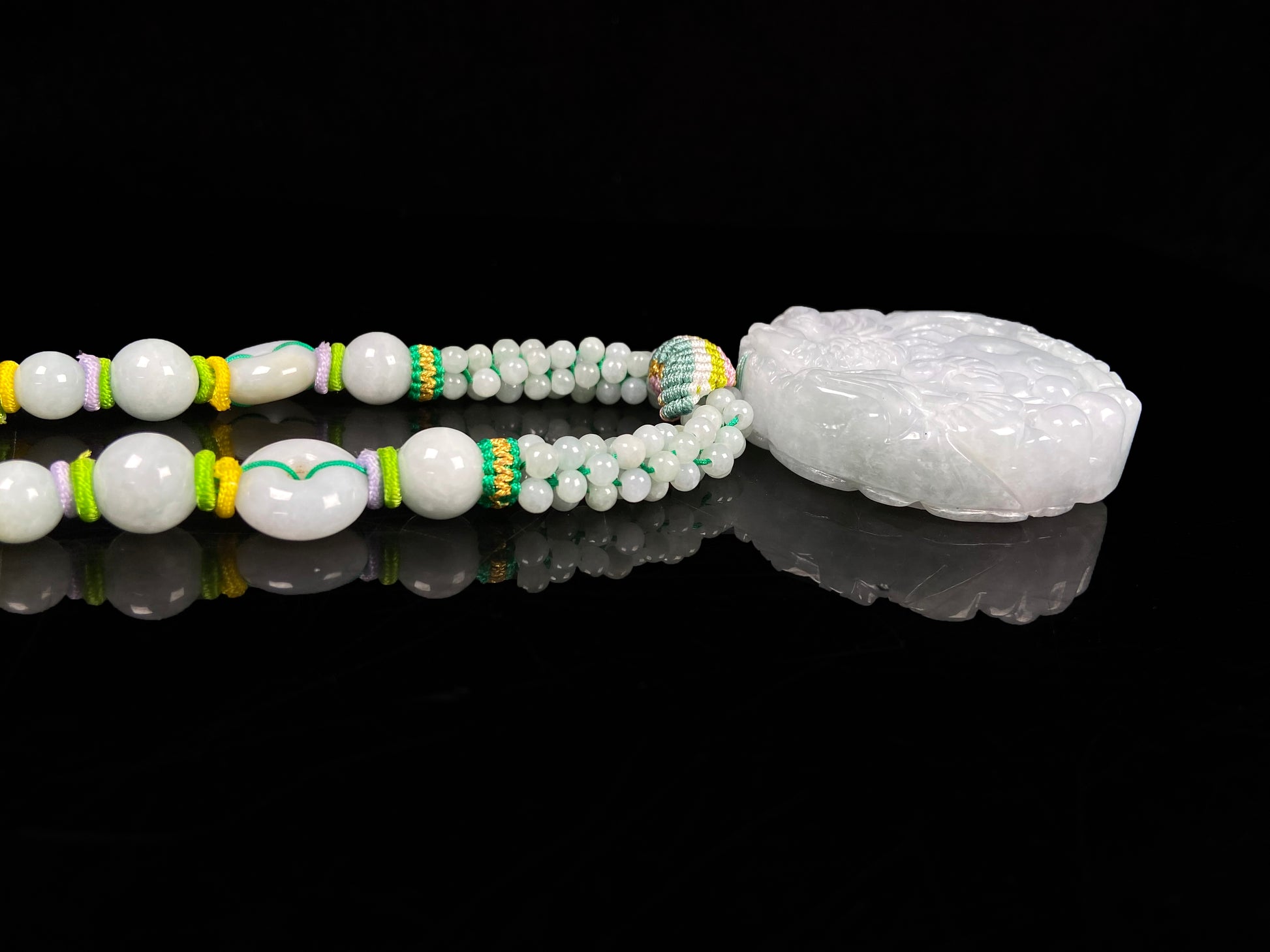 A phoenix among clouds jadeite pendant.