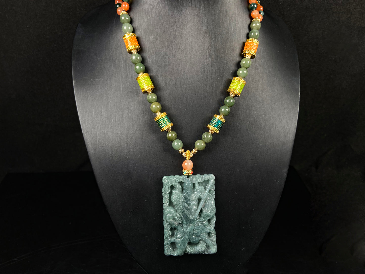 A deep green mighty guan gong jadeite pendant.