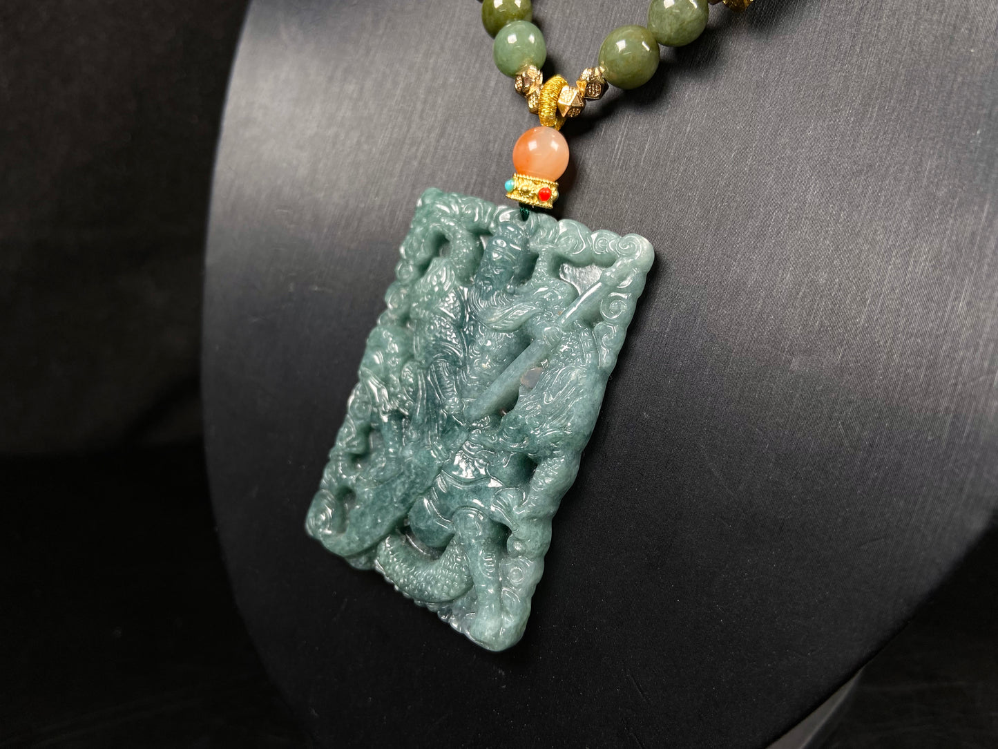 A deep green mighty guan gong jadeite pendant.