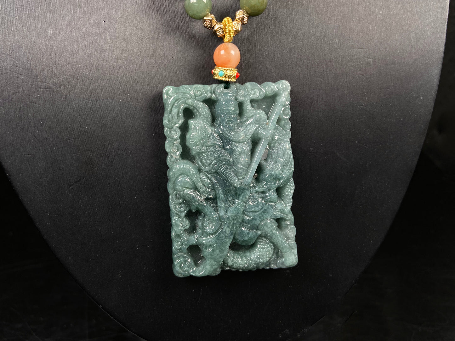 A deep green mighty guan gong jadeite pendant.