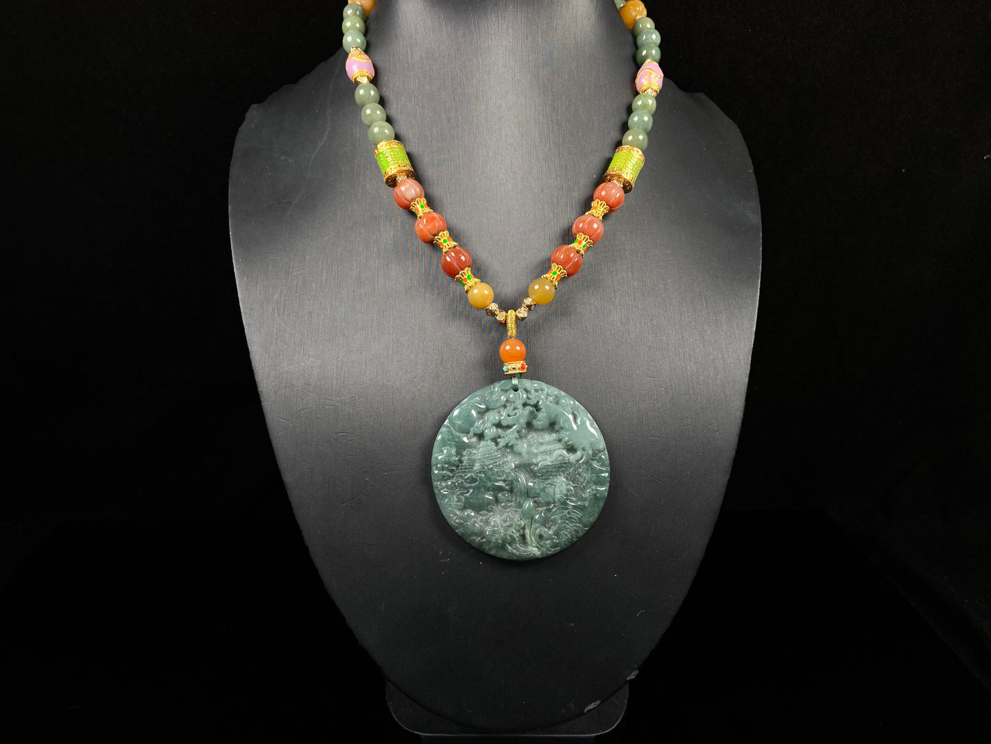 A deep green mountain scenery  jadeite pendant.