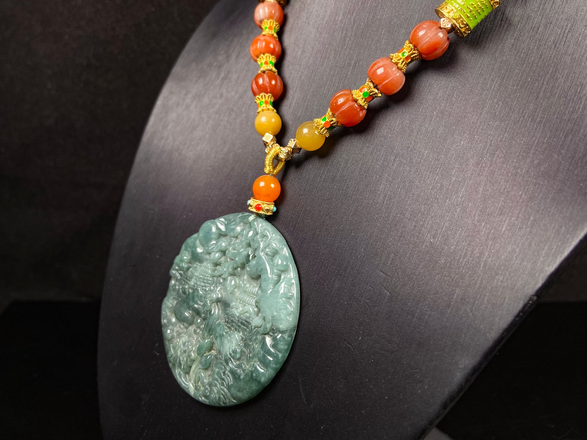 A deep green mountain scenery  jadeite pendant.