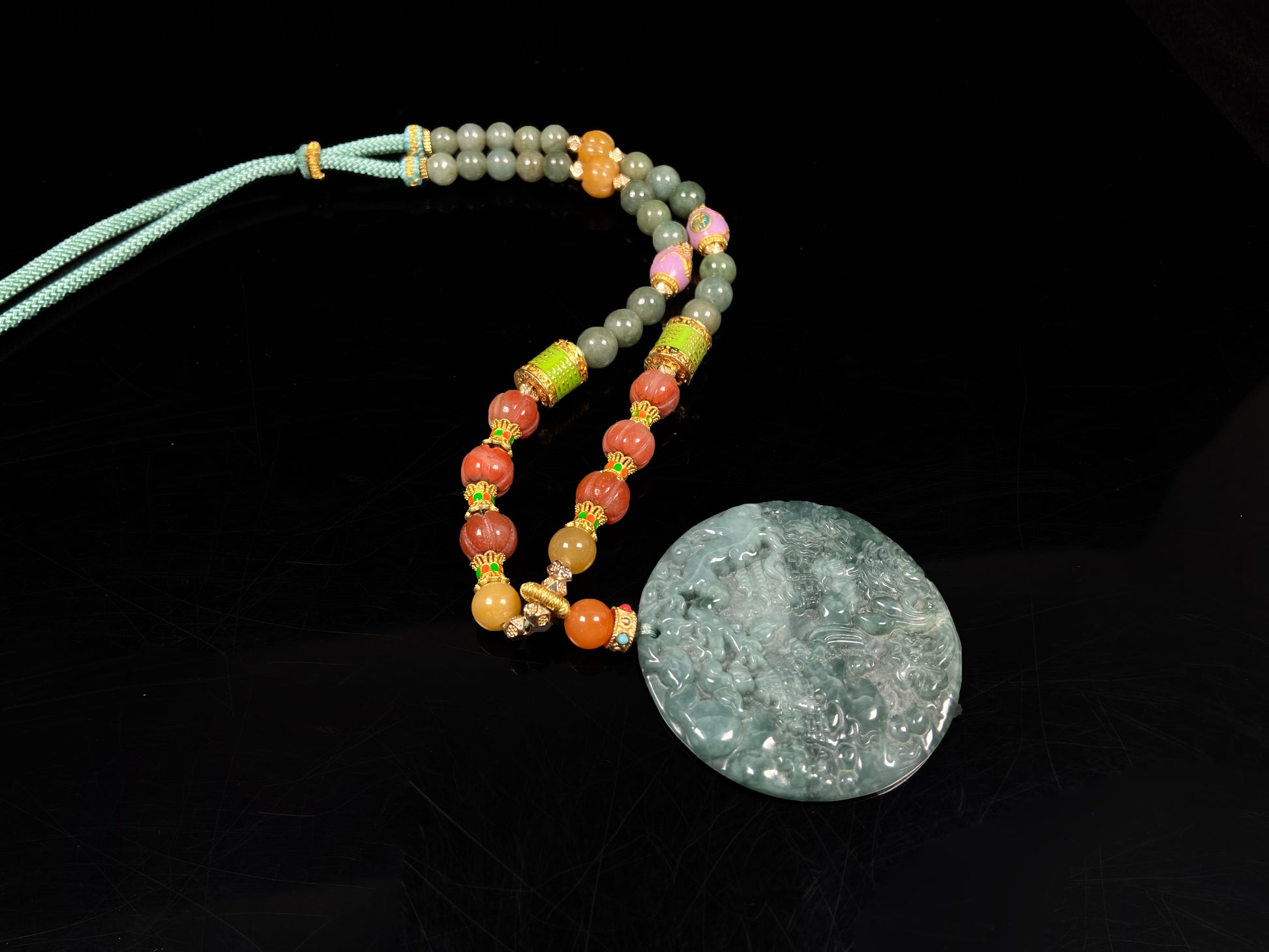 A deep green mountain scenery  jadeite pendant.