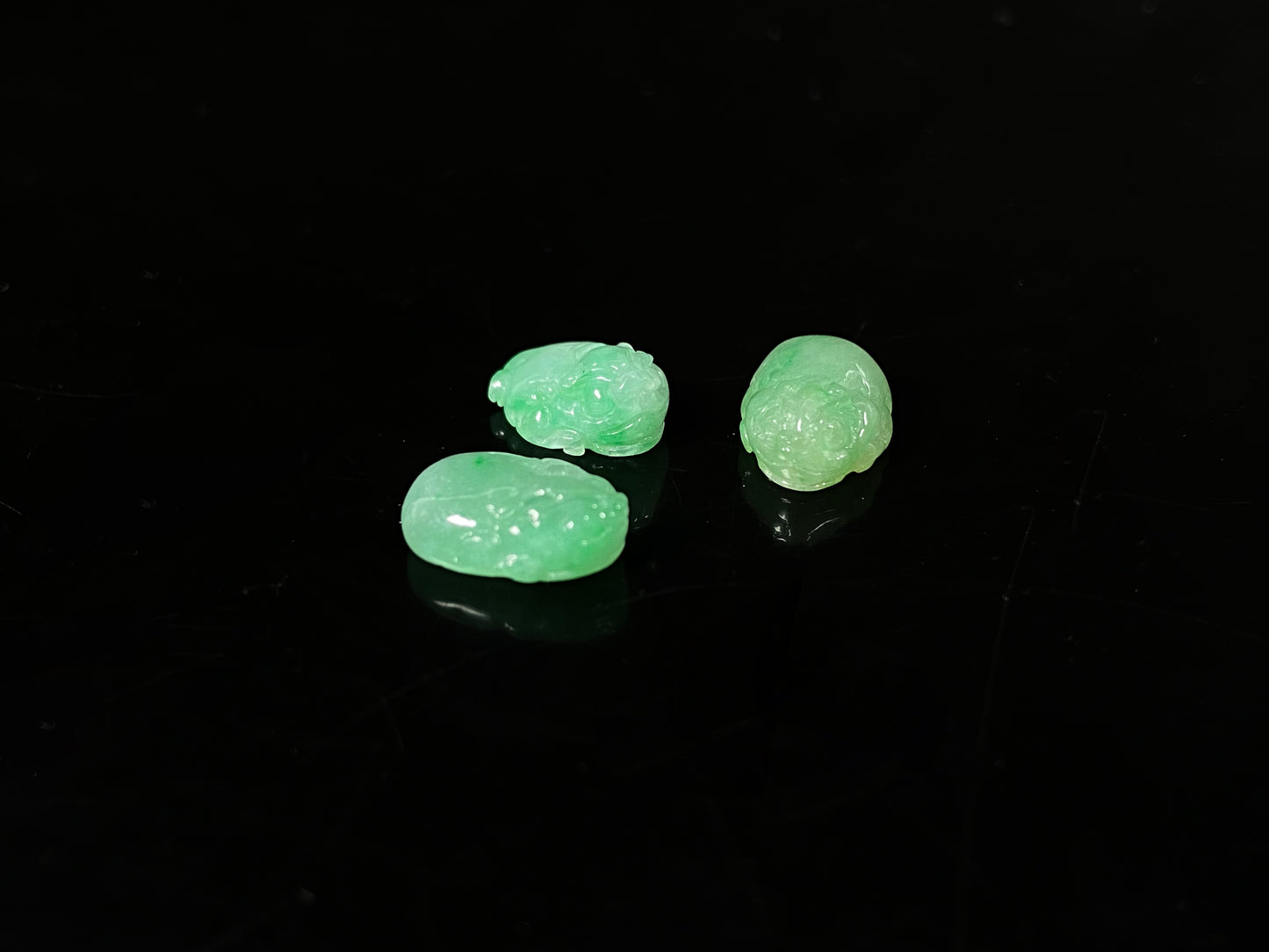 A three piece green toned pixiu set loose jadeite.