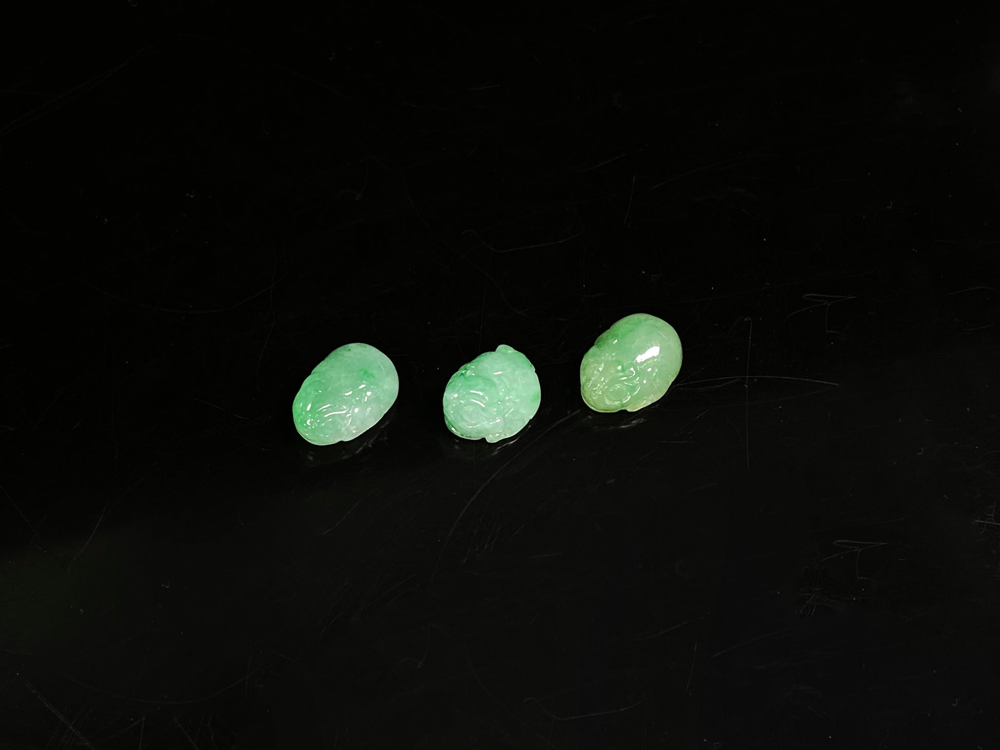 A three piece green toned pixiu set loose jadeite.