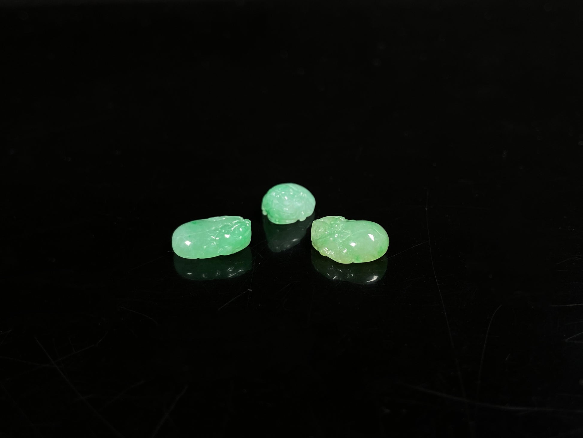 A three piece green toned pixiu set loose jadeite.