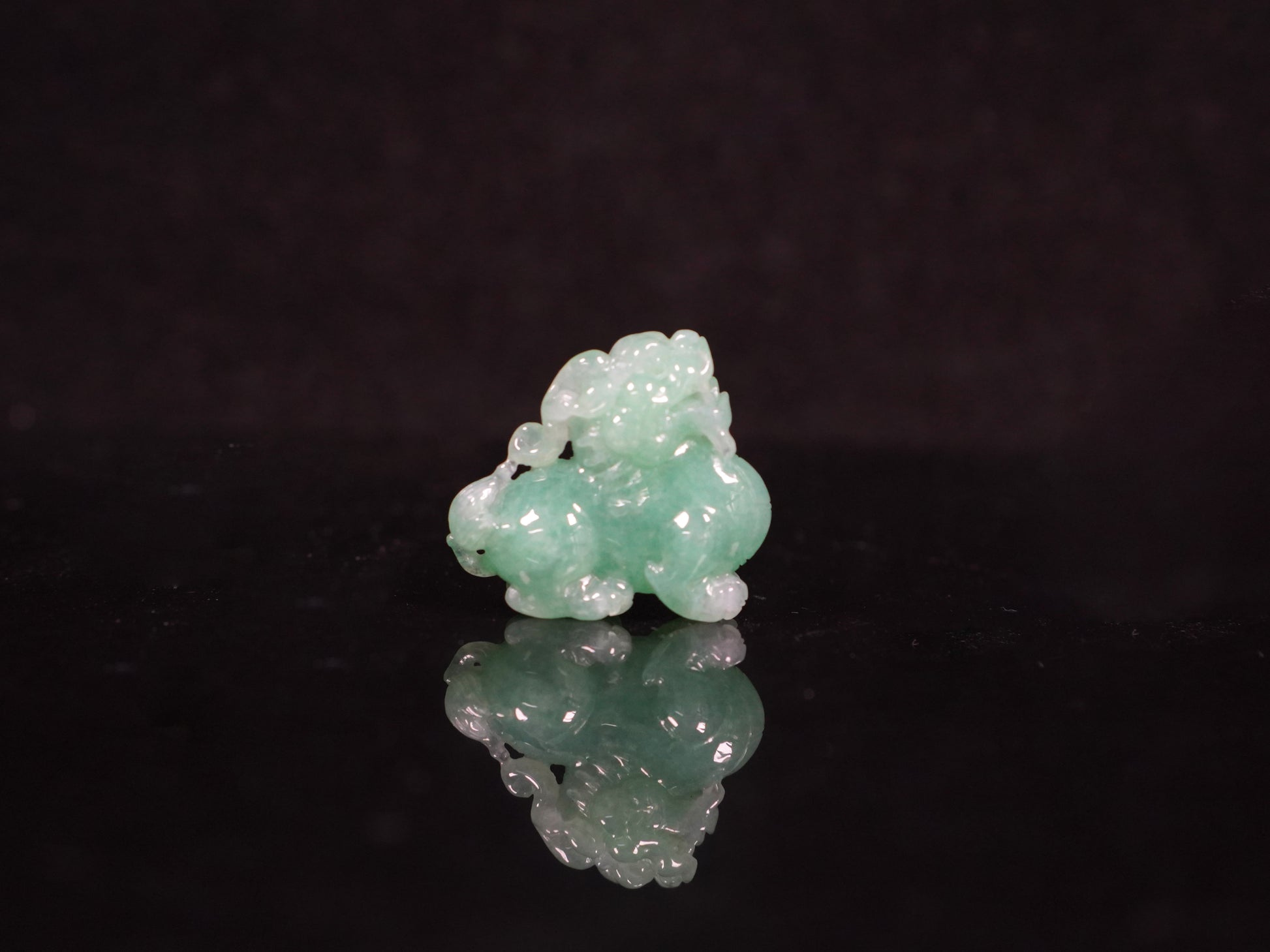 A luminous mint green Pixiu loose jadeite.
