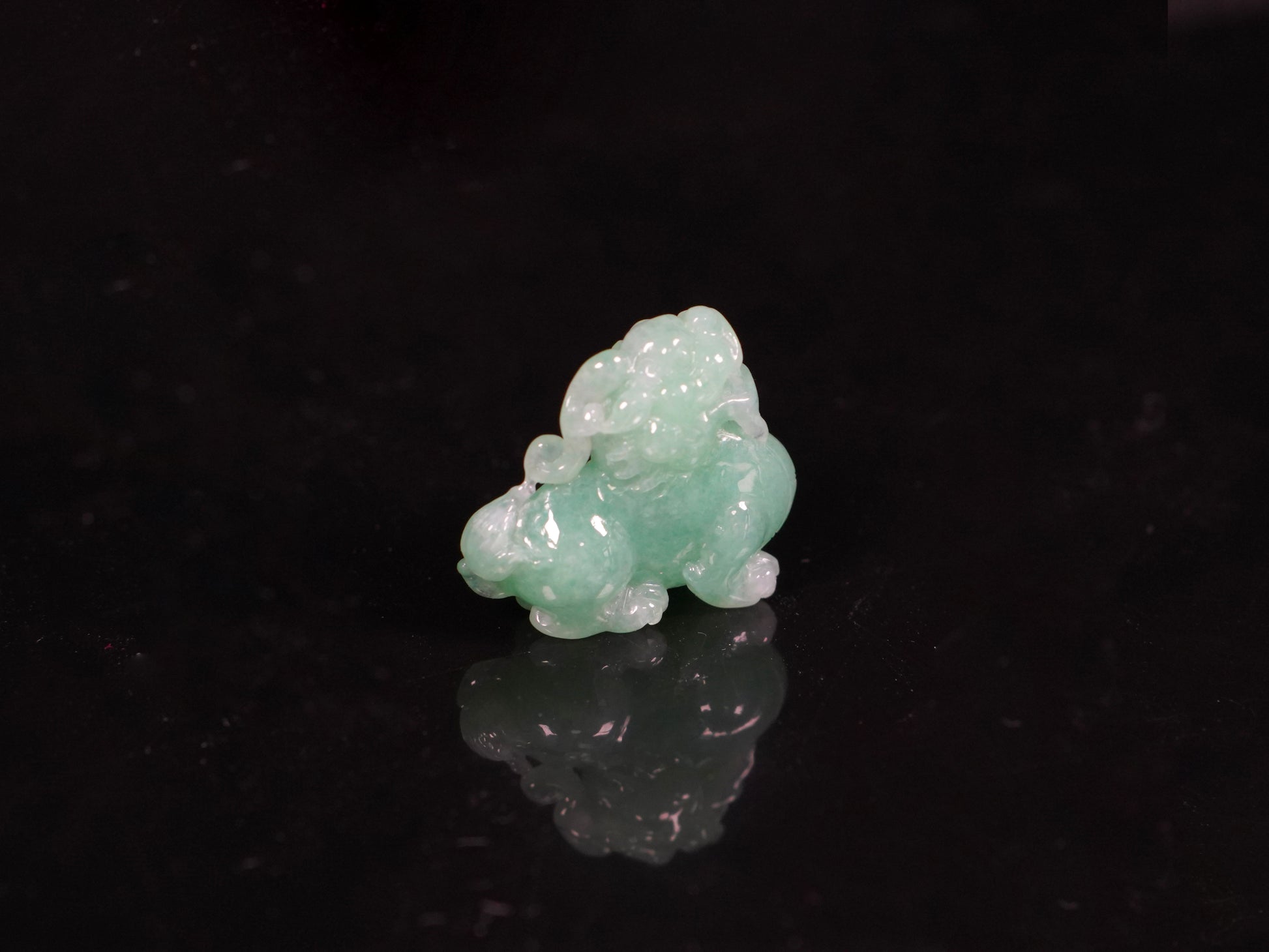 A luminous mint green Pixiu loose jadeite.