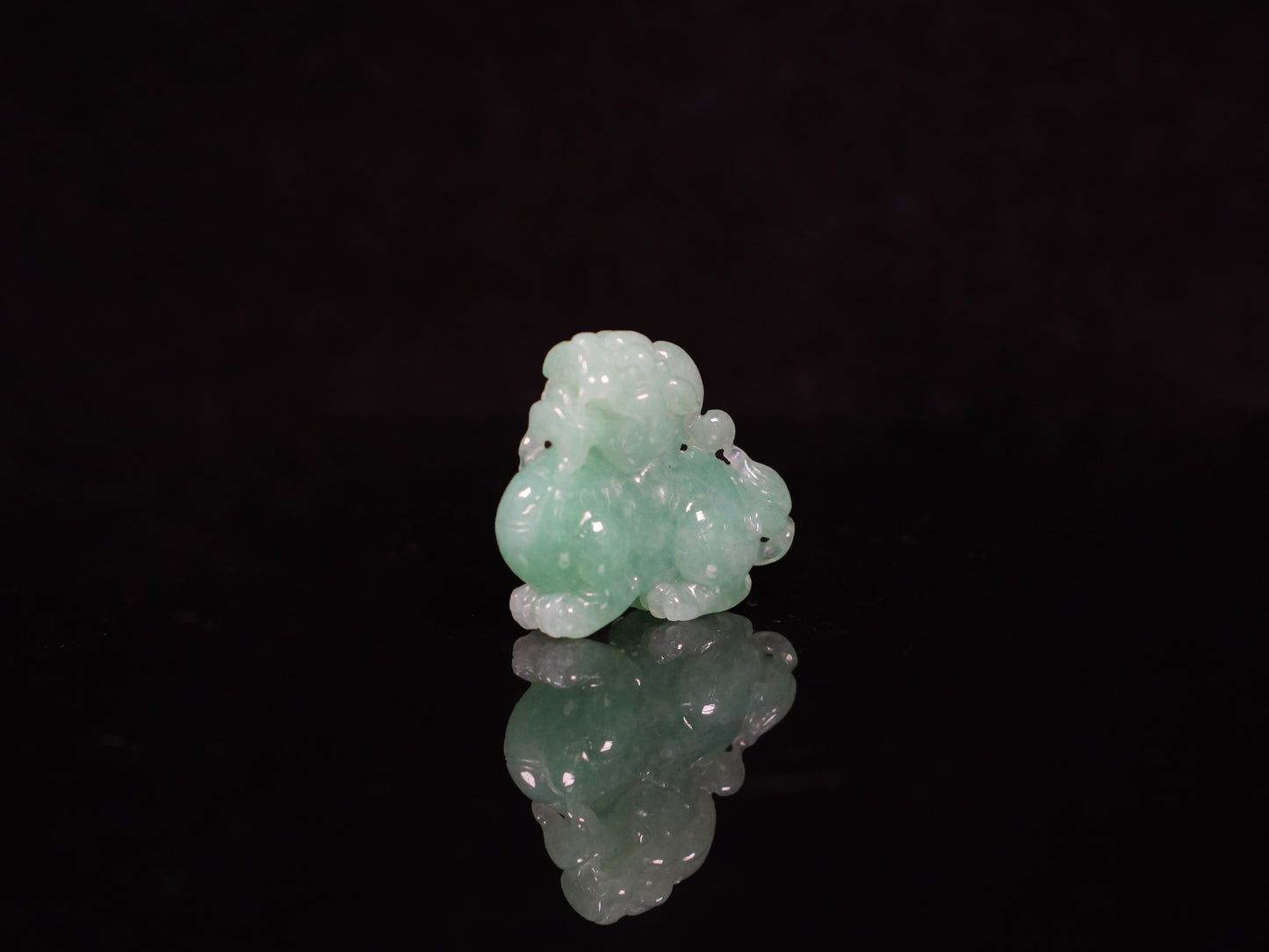 A luminous mint green Pixiu loose jadeite.