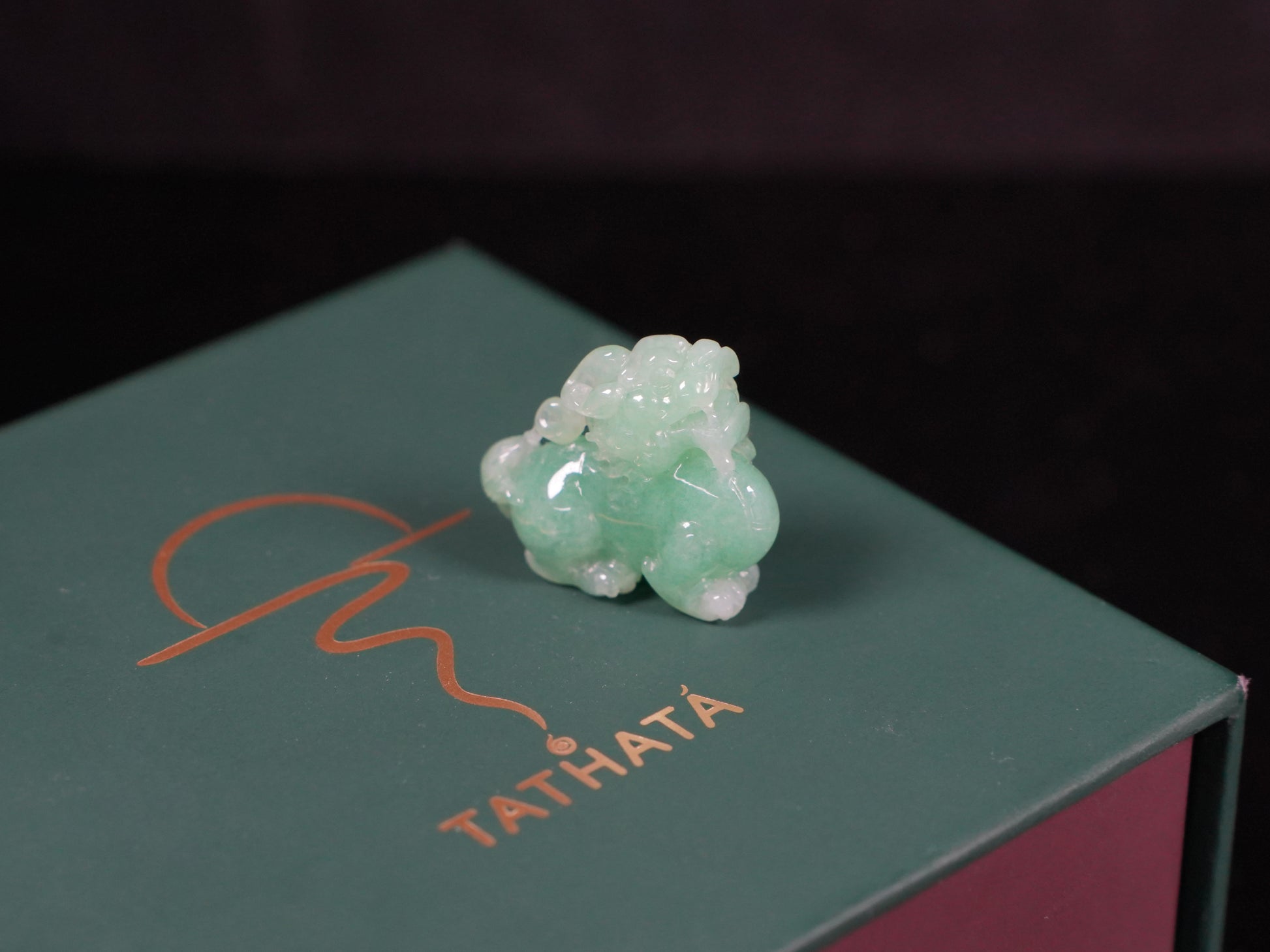 A luminous mint green Pixiu loose jadeite.