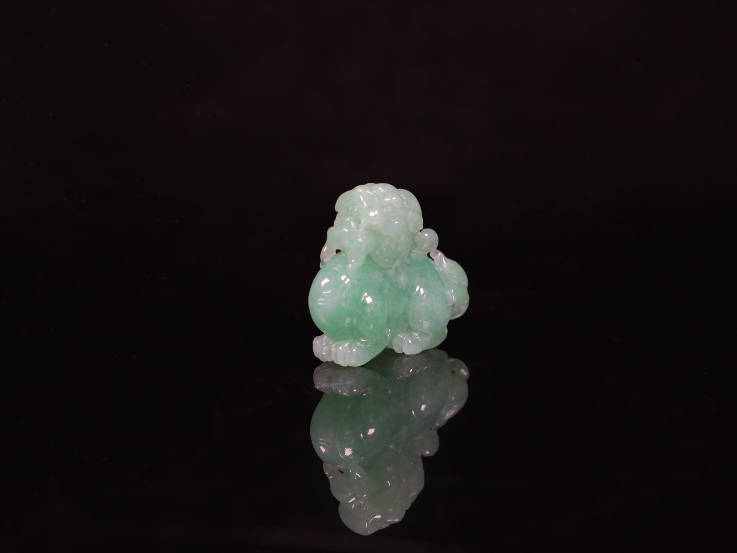 A luminous mint green Pixiu loose jadeite.