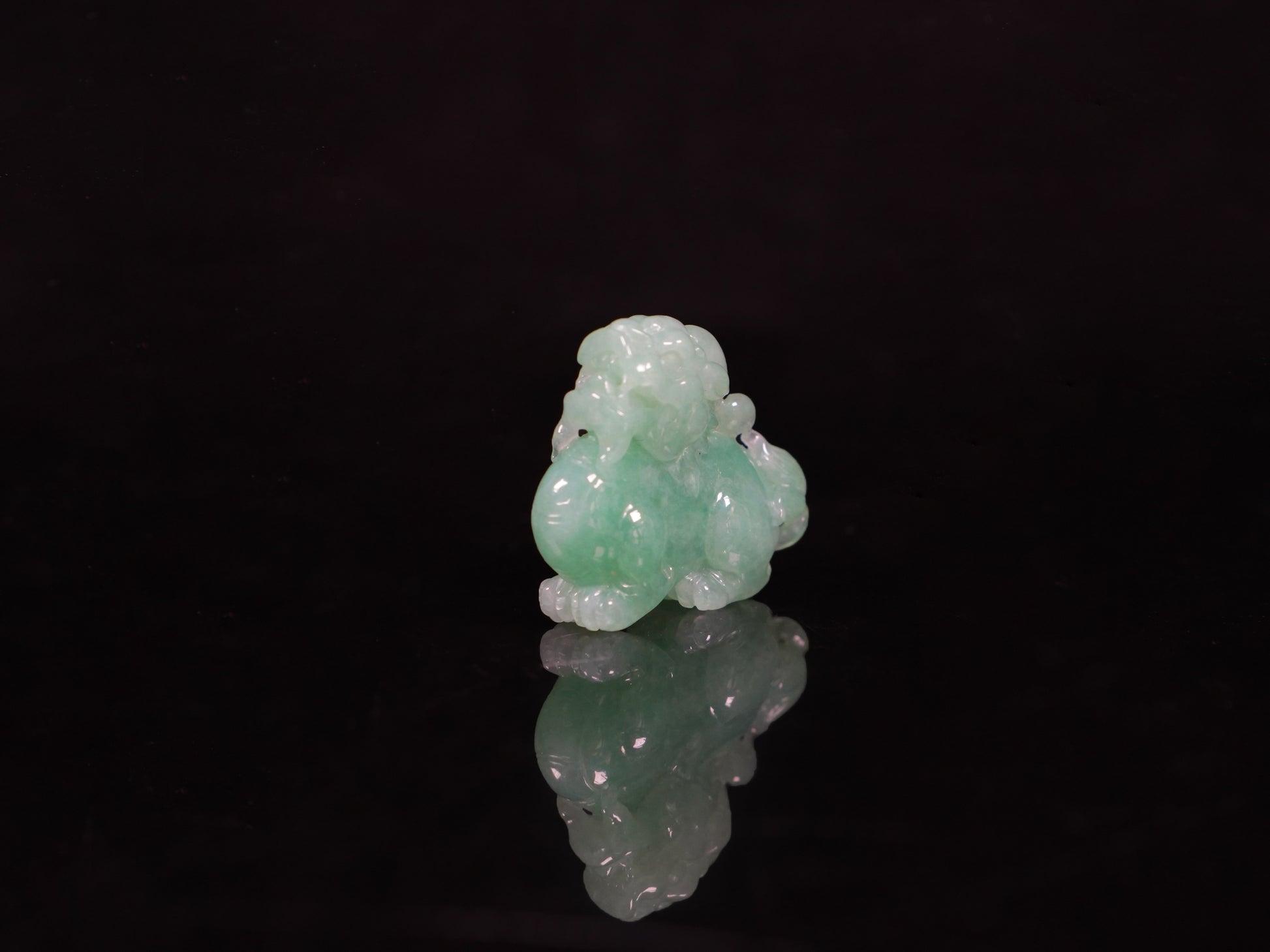 A luminous mint green Pixiu loose jadeite.