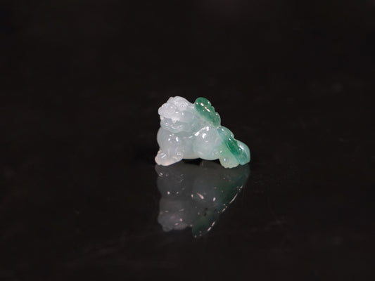 A translucent base green Pixiu loose jadeite.