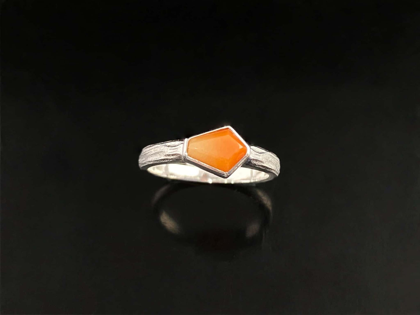 A sunset orange gradient jadeite ring.
