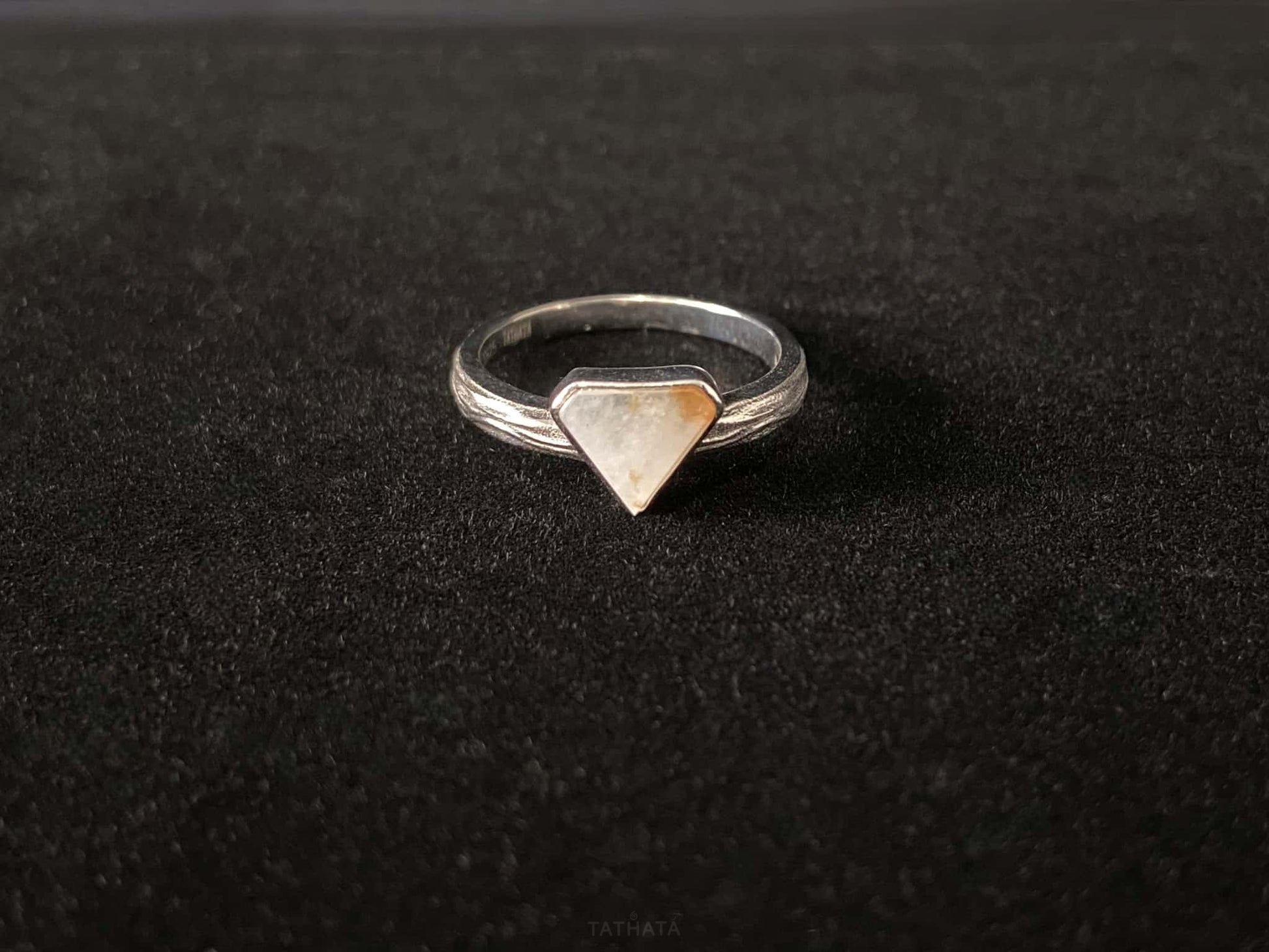 A sunset sugar triangle jadeite ring.