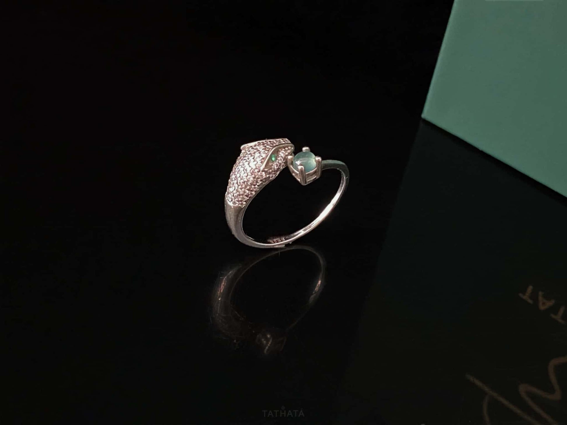 A silver serpent bite jadeite ring.