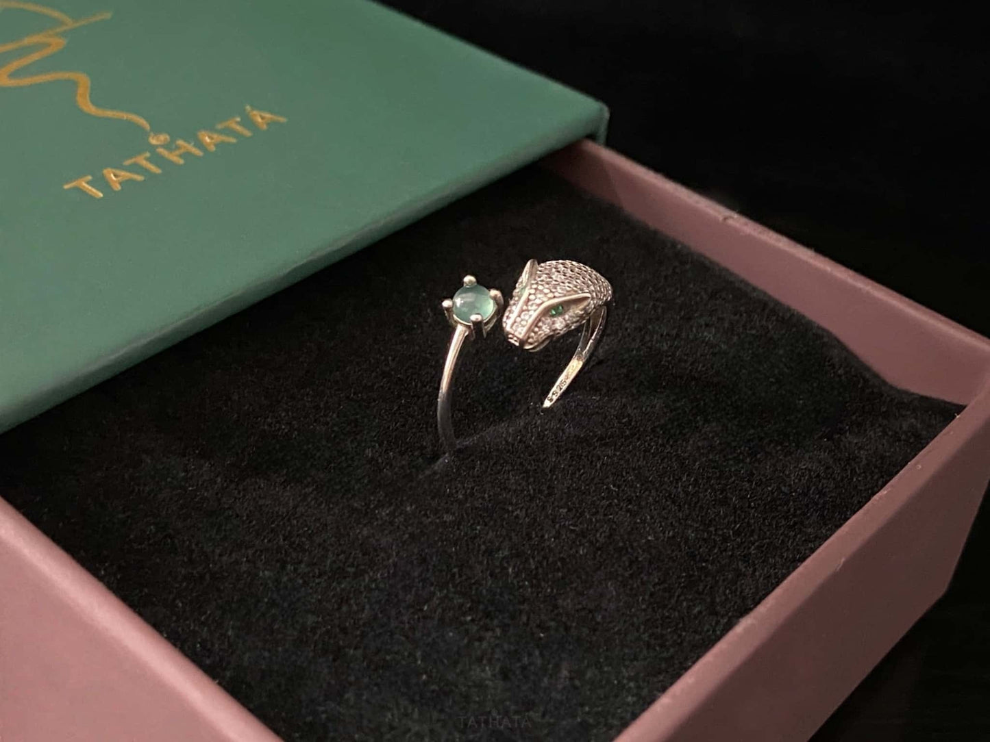 A silver serpent bite jadeite ring.