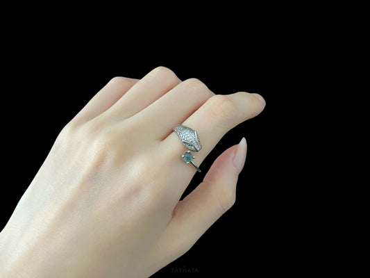 A silver serpent bite jadeite ring.