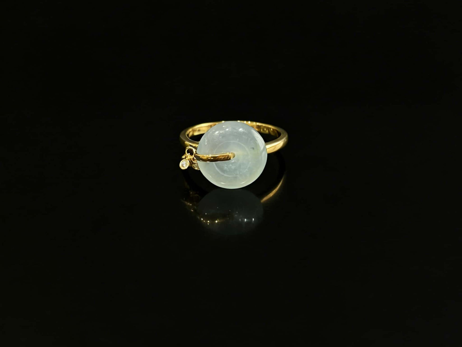 A green frost peace button jadeite ring.