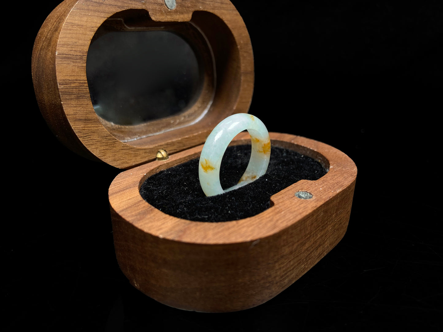 A misty white with amber fleck jadeite ring.