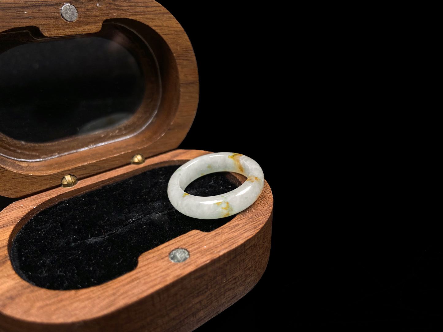 A misty white with amber fleck jadeite ring.