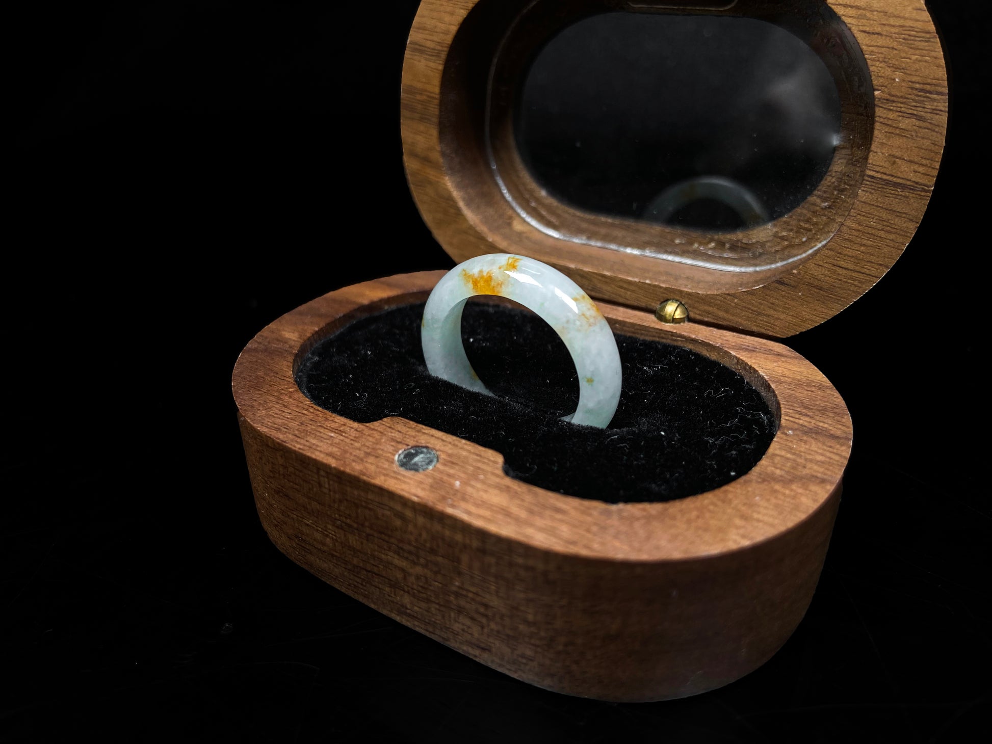 A misty white with amber fleck jadeite ring.