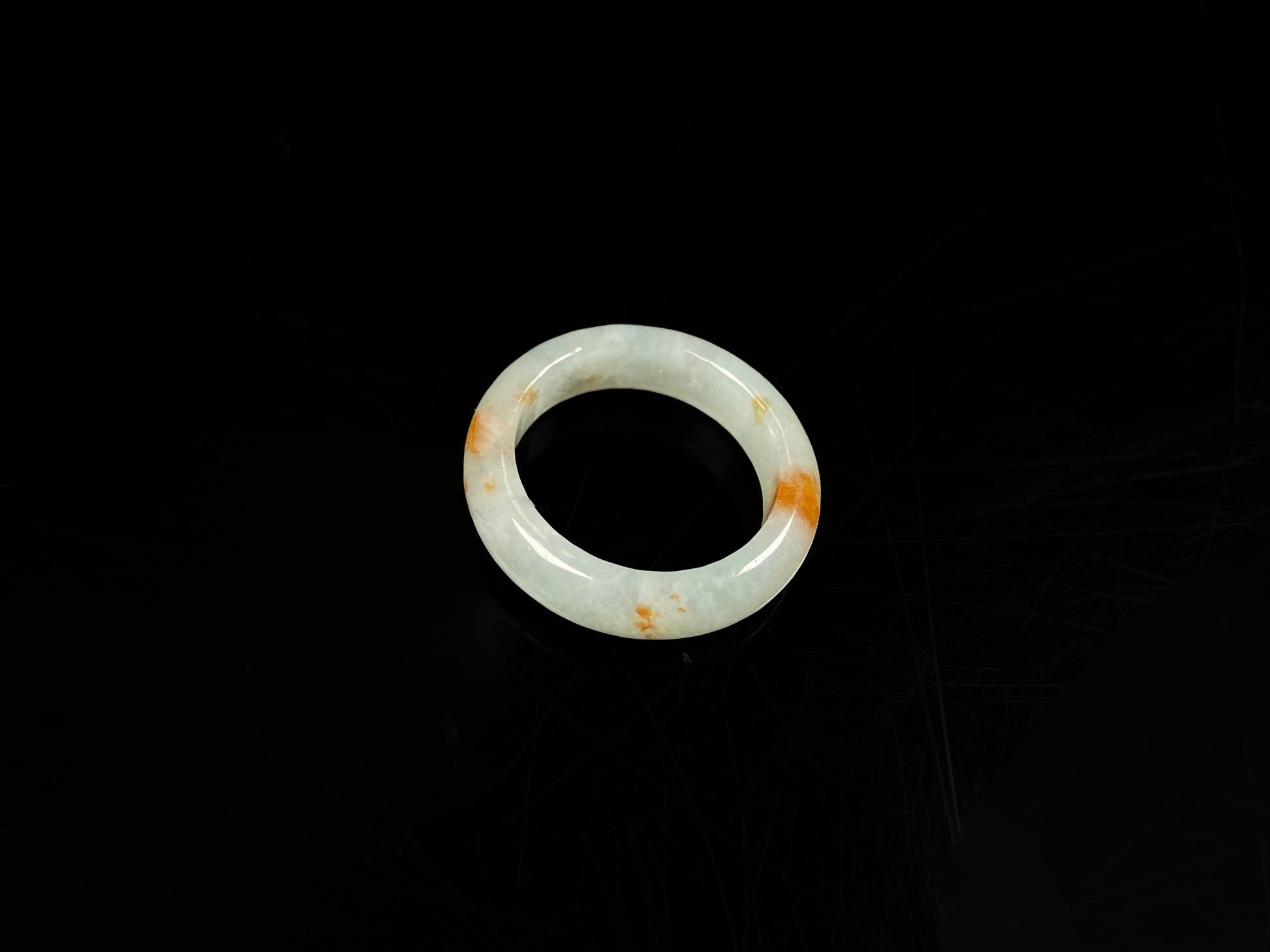 A icy white with amber hue jadeite ring.