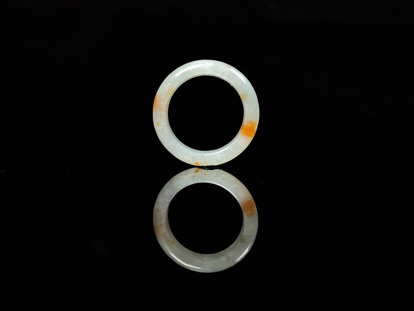 A icy white with amber hue jadeite ring.