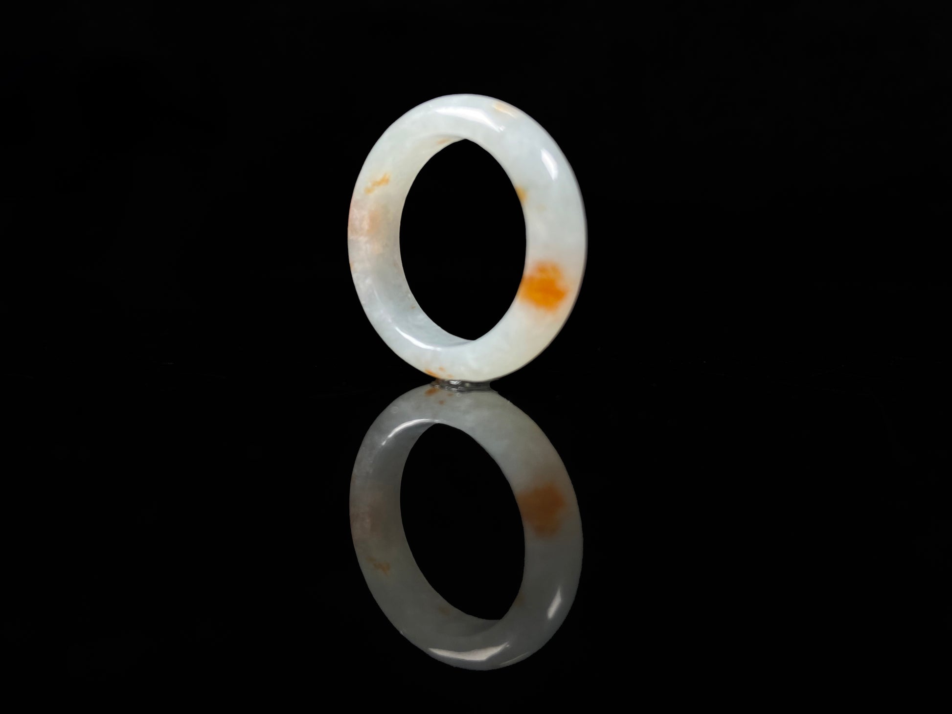 A icy white with amber hue jadeite ring.